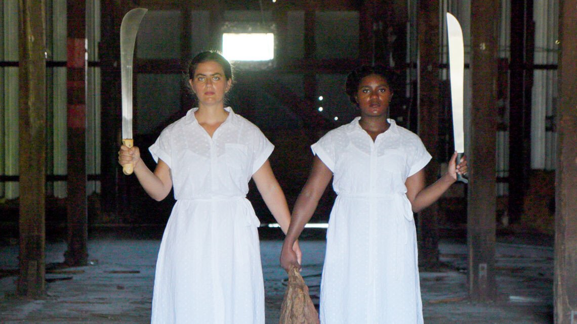 two people holding hands and machetes