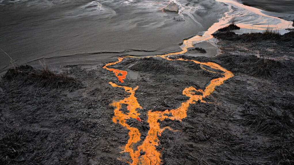 Image of black and white landscape with orange liquid