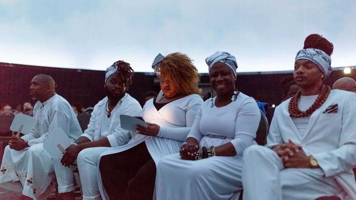 group of individuals sitting, wearing white