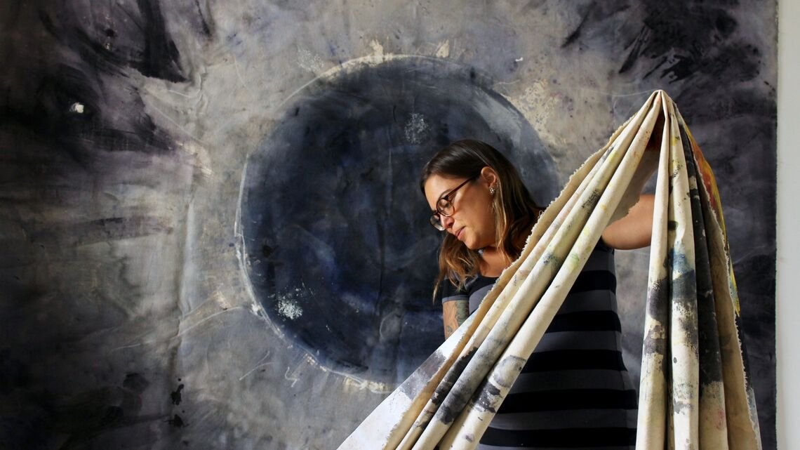 Person holding folded tapestry