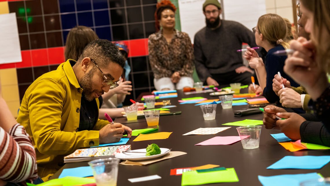Rising Wing members at a table filling out cards