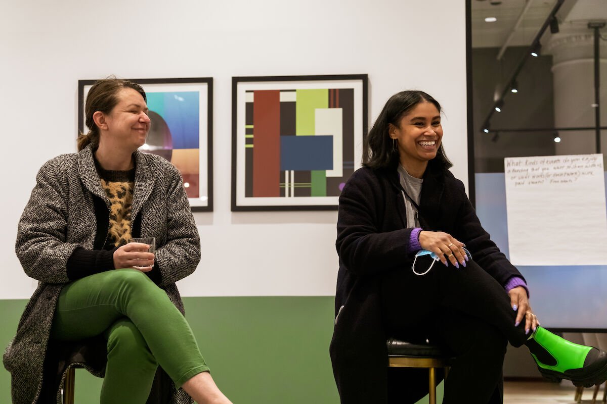 Two seated Rising Wing members