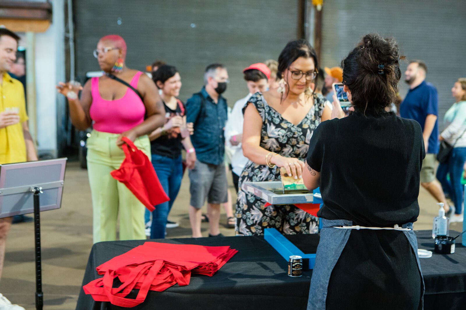 A guest partakes in the screen-printing art activity during the opening reception